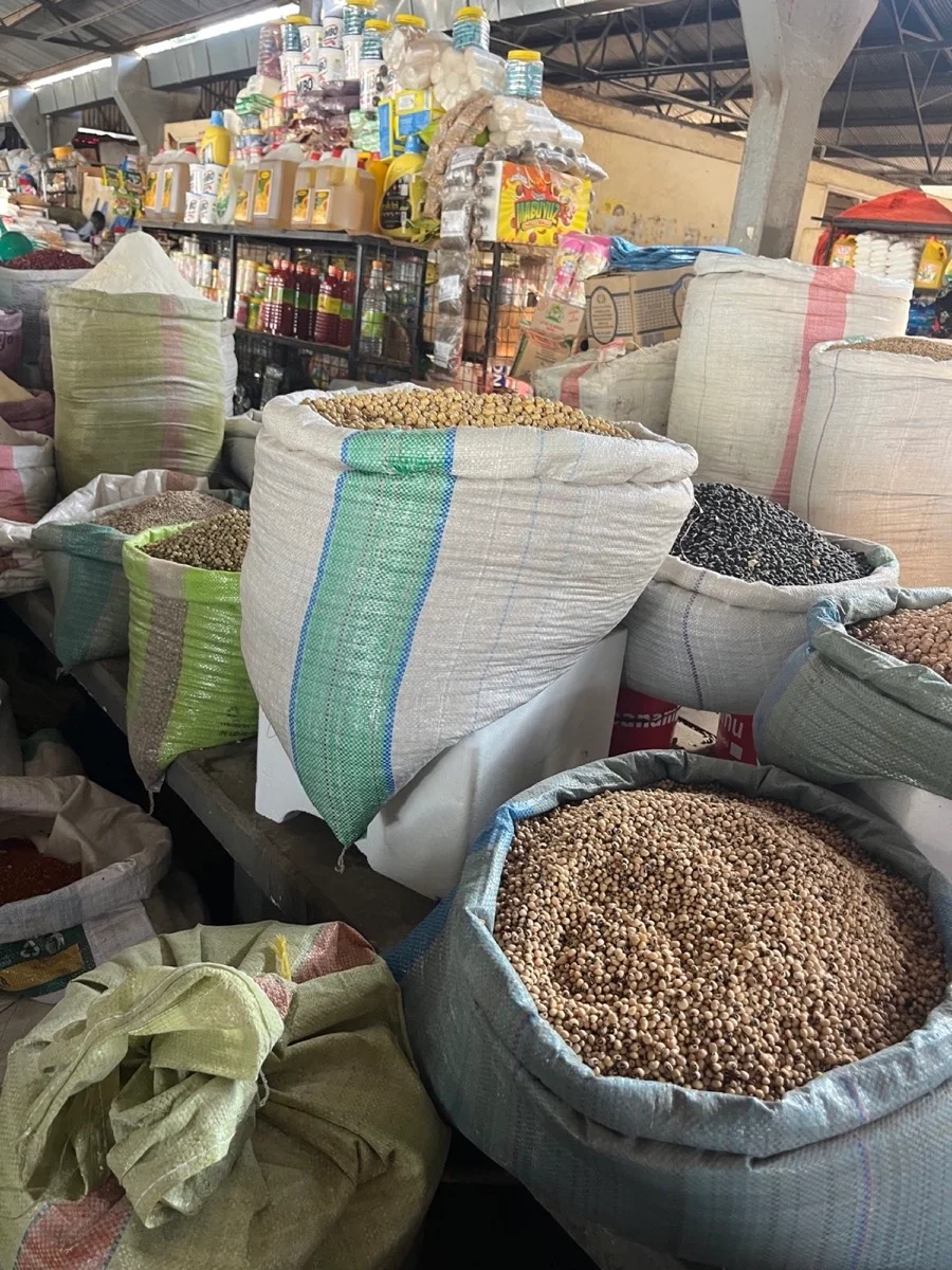 Open sacks of locally sold beans and grains inside a Tanzanian market