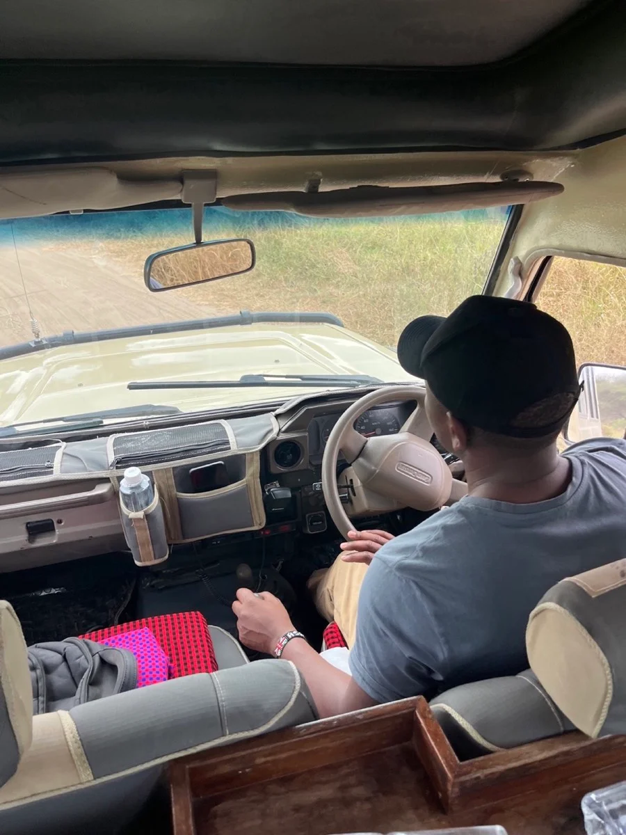A Tanzanian safari guide driving through the landscape