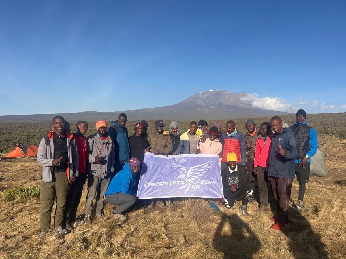 The Tanzanian mountain team gathered beneath Mount Kilimanjaro