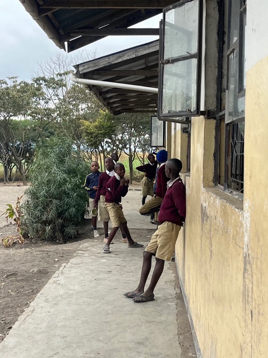 Tanzanian students spending time outside their school